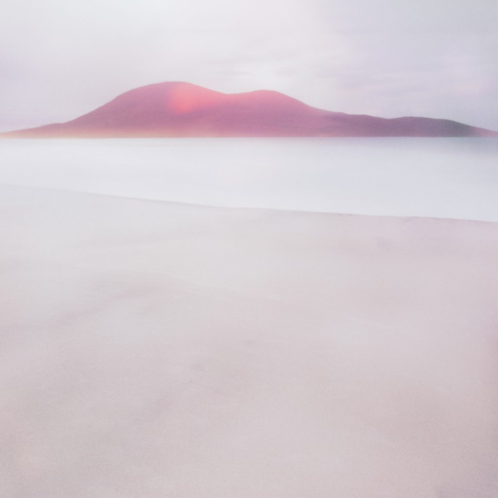Soft pink light on a rounded mountain rising above pale, mist-like water, with a faint diagonal shoreline in the foreground.